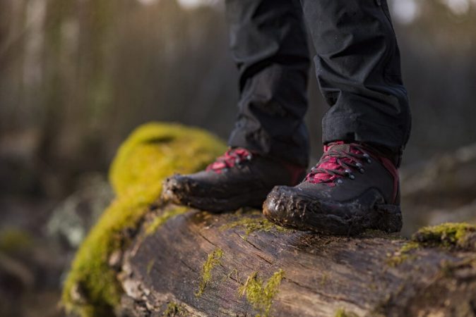 person-in-hiking-boots-standing-on-log-1024x683