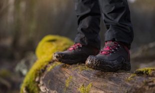 person-in-hiking-boots-standing-on-log-1024x683